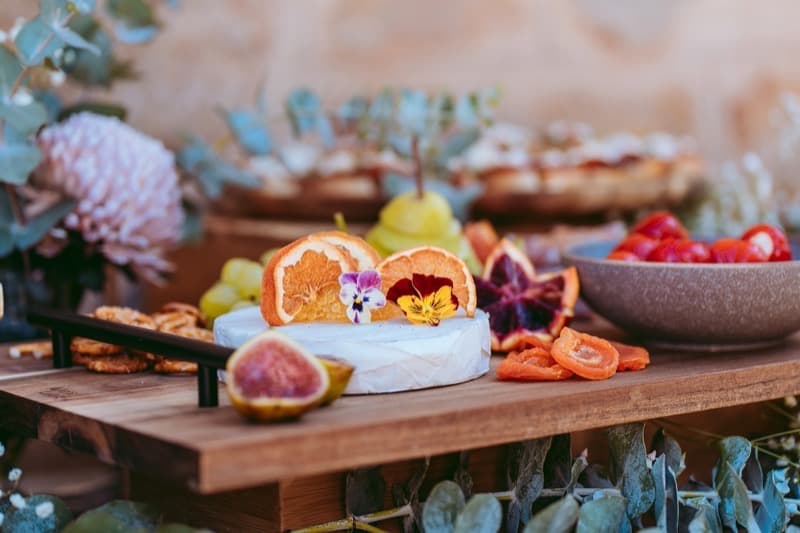 Brie wheel with dried orange, edible pansies and figs on a Barossa Valley grazing board